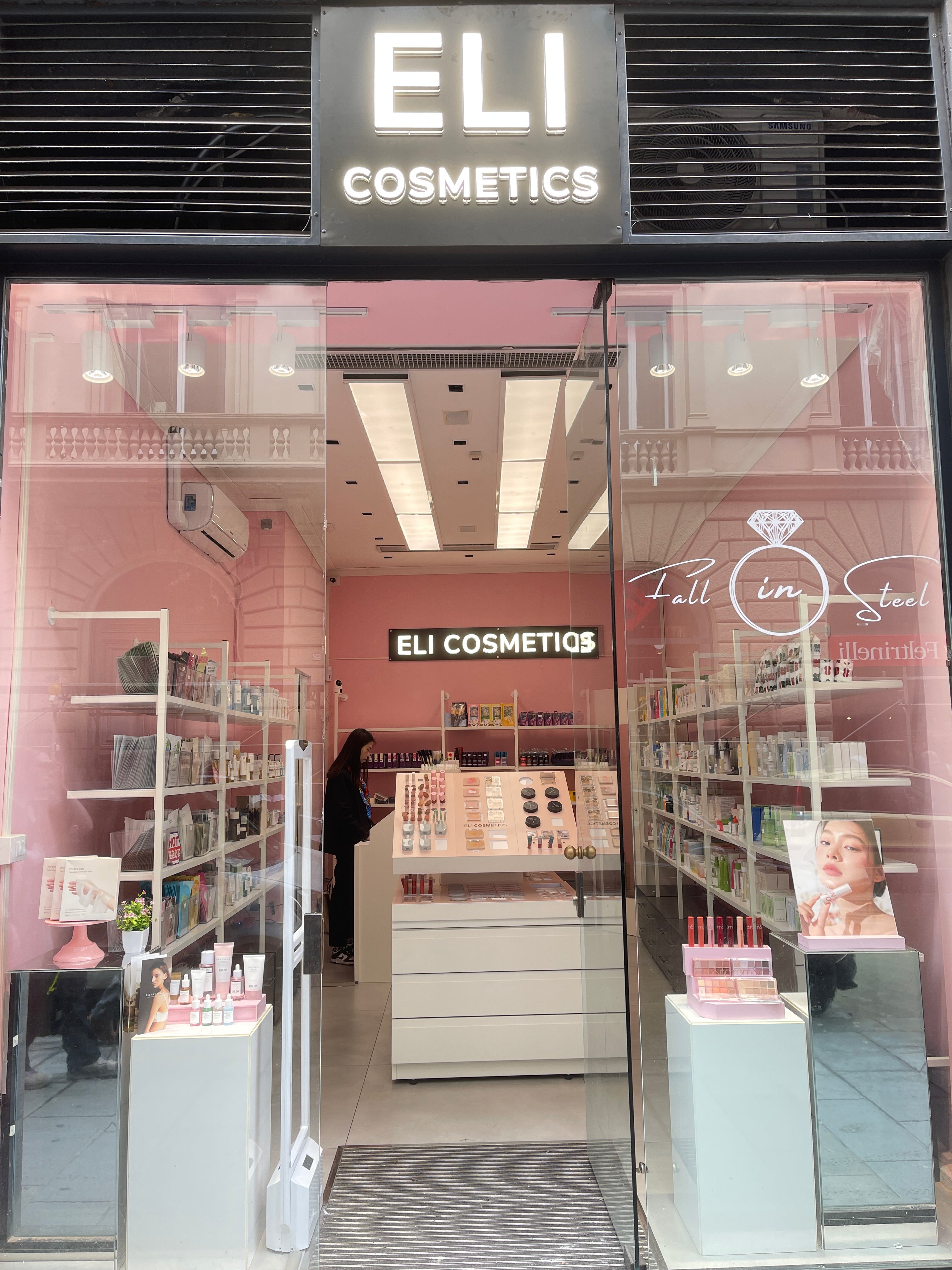 Cosmetic store with glass facade and interior display.