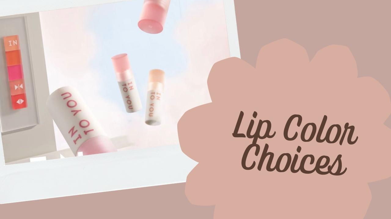 Southern European woman softly diffusing rose lip colour beside lip mud, fudge tint and gloss products in natural late-summer light.