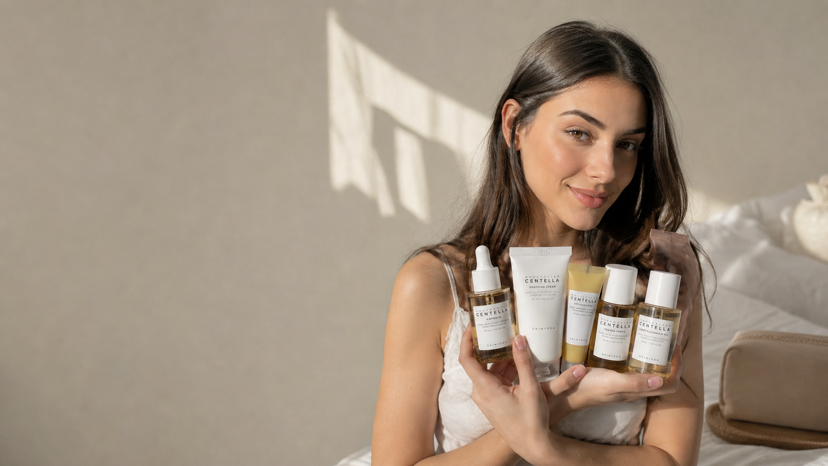 Woman holding a streamlined SKIN1004 Centella skincare selection in warm natural light after returning from holiday.