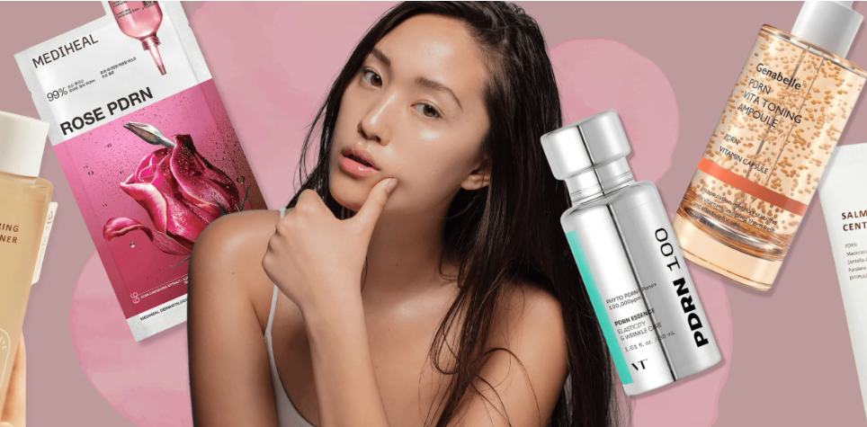 Woman applying a lightweight PDRN serum at a naturally lit bathroom vanity with a real serum bottle, toner-pad jar and mask nearby.