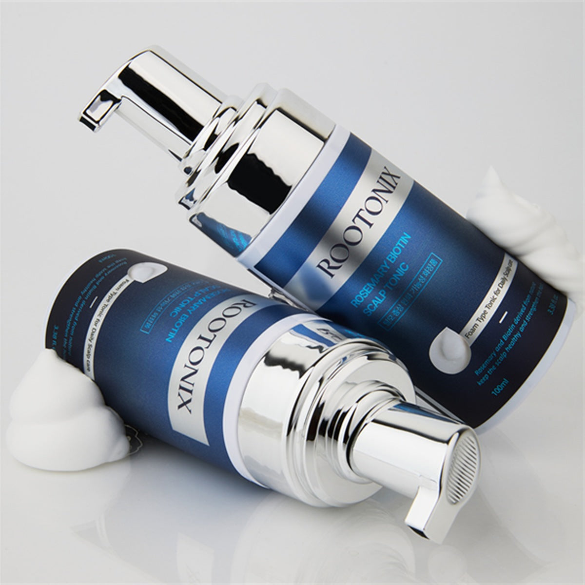 Two ROOTONIX Rosemary Biotin Scalp Tonic bottles with foam texture